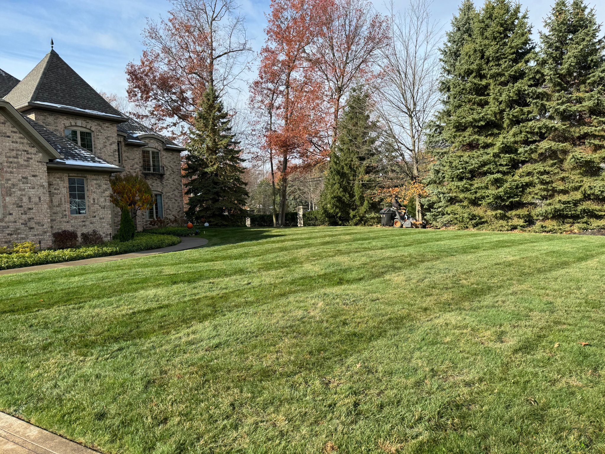 Lawn mowing with crisp stripes at a stone estate